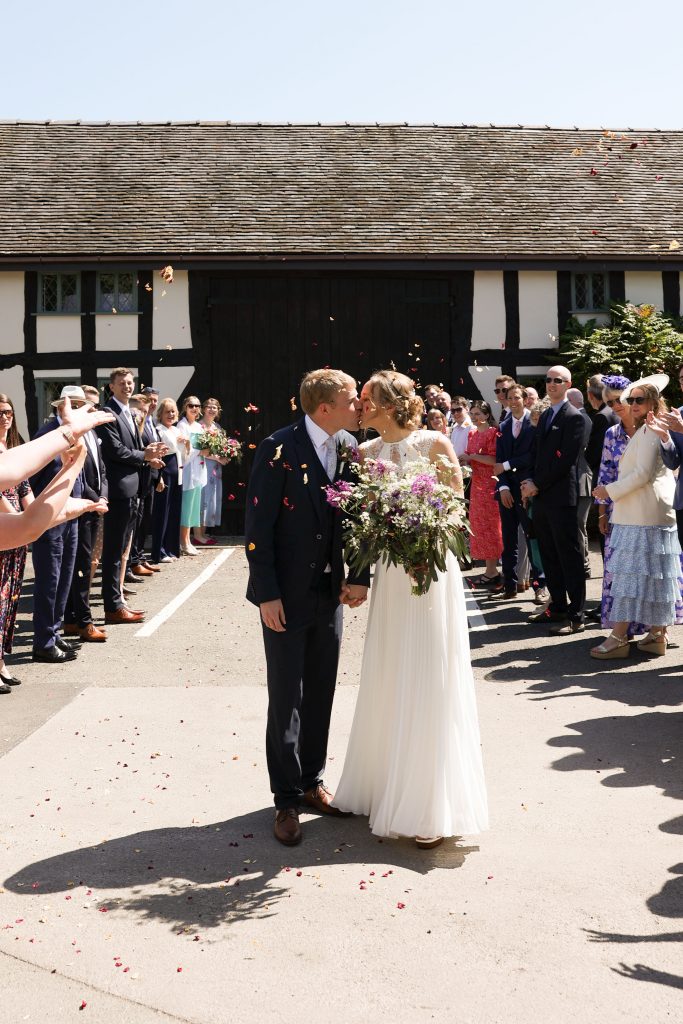 Confetti should with kisses by the barn door