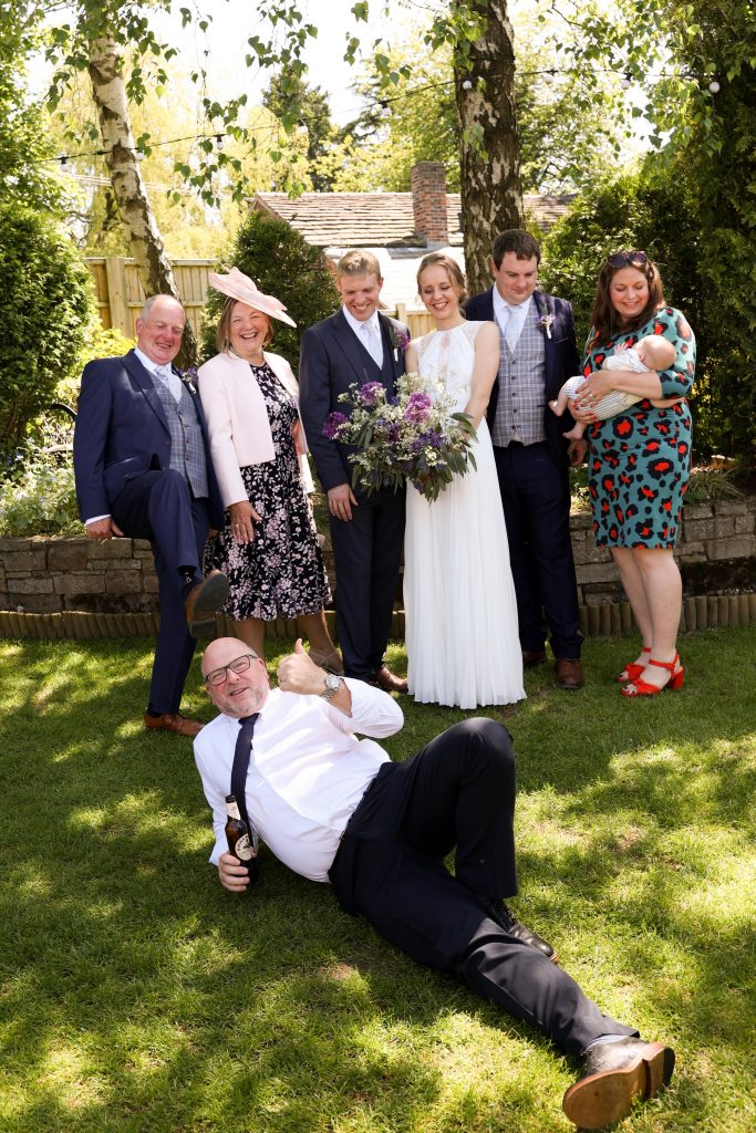 Silly group photos with a man lay onthe floor