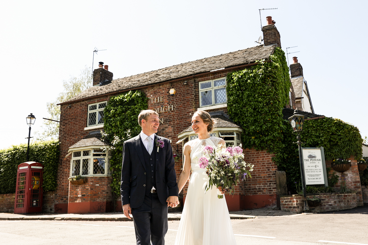 A newly married couple in front of The Plough Inn at Eaton