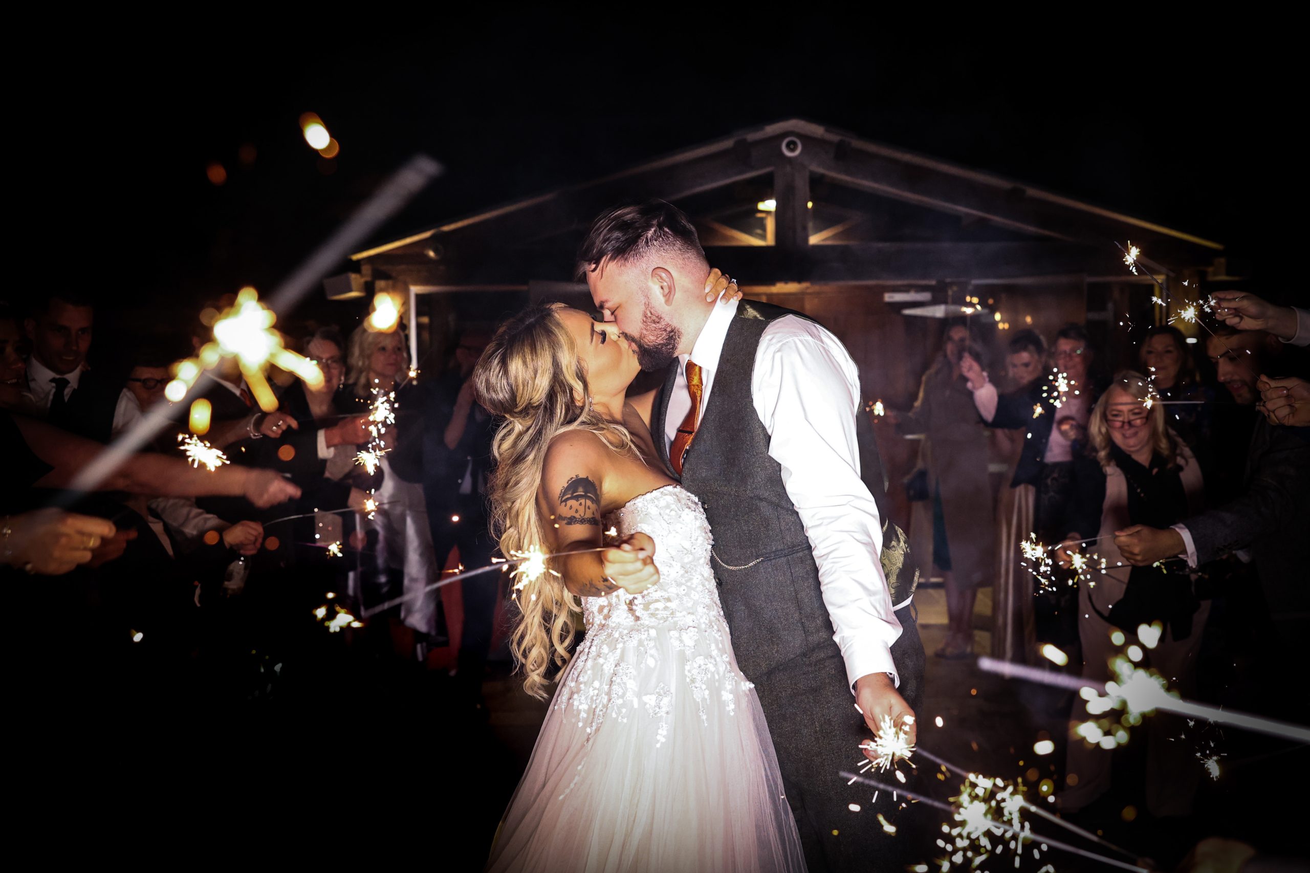 A modern, candid, wedding sparklers photo, taken at Owen House Wedding Barn.