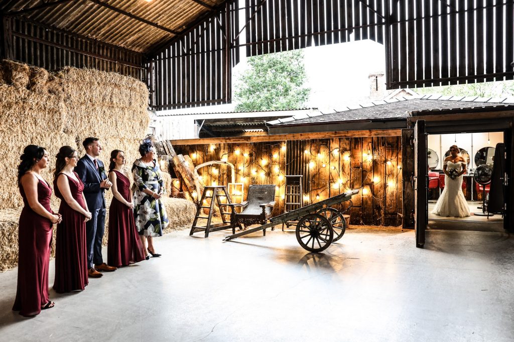 A beautiful, candid moment of anticipation and joy during a first look at Owen House Wedding Barn