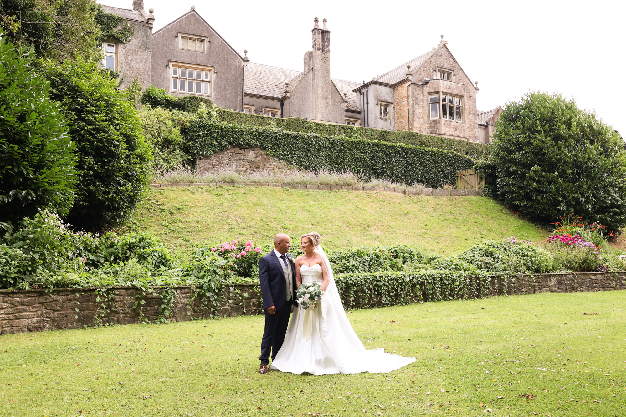 The newly married couple posing on the lawn of Mitton Hall.