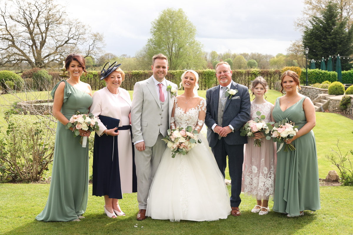 Traditional wedding group photo on the lawn at Rookery Hall.