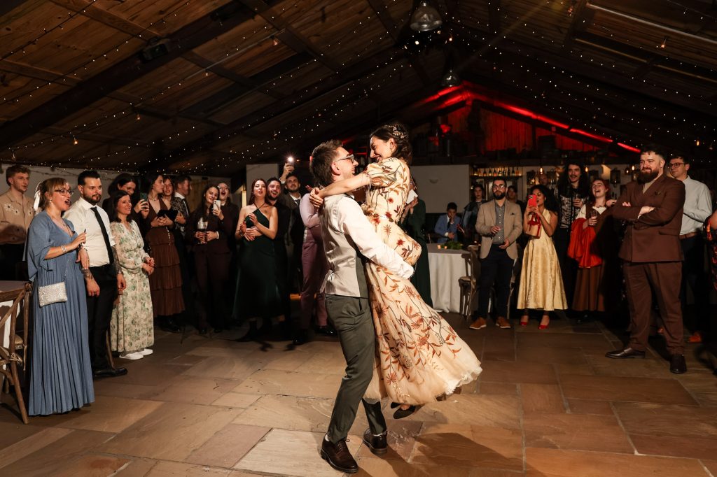 Dramatic lighting during a magical first dance at Owen House Wedding Barn