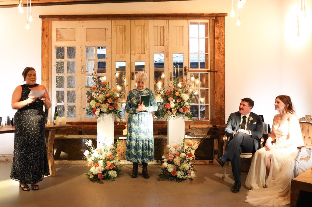 A heartfelt wedding blessing ceremony taking place in the rustic barn at Owen House Wedding Barn